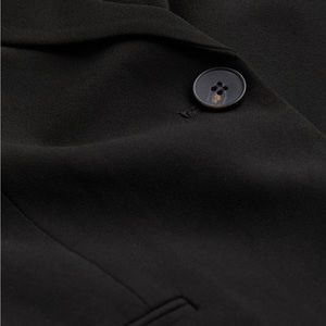 Black relaxed fit straight cut jacket.